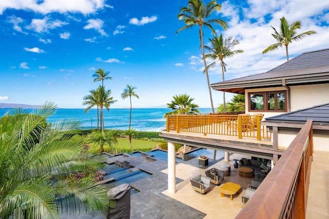 exterior space with a water view, an outdoor hangout area, and a balcony