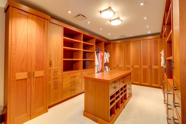 walk in closet featuring light colored carpet