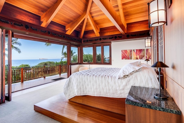 bedroom with lofted ceiling with beams, carpet floors, a water view, and wooden ceiling