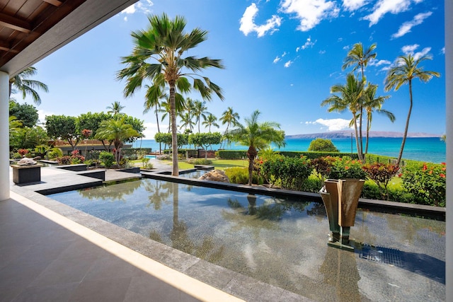 view of pool with a water view