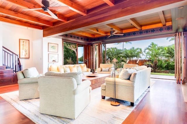 living room featuring plenty of natural light, beamed ceiling, and wooden ceiling