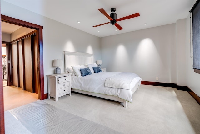 bedroom with ceiling fan and light carpet