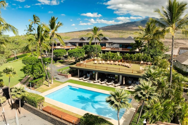 view of swimming pool with a mountain view