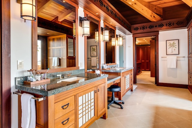 bathroom with beam ceiling, tile patterned flooring, vanity, and wooden ceiling