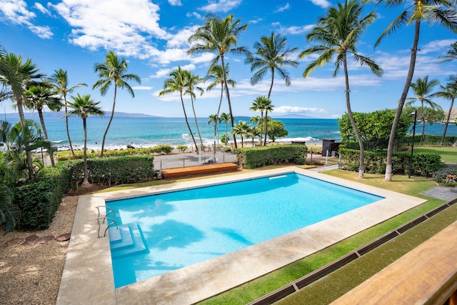 view of swimming pool with a water view