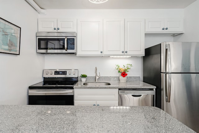 kitchen with white cabinetry, sink, and stainless steel appliances