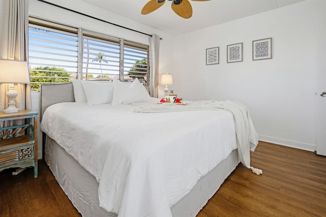 bedroom with ceiling fan and dark hardwood / wood-style flooring