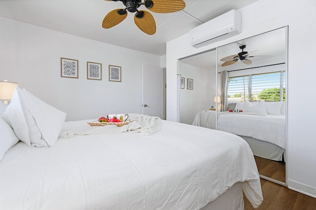 bedroom with a closet, a wall mounted AC, ceiling fan, and dark hardwood / wood-style flooring