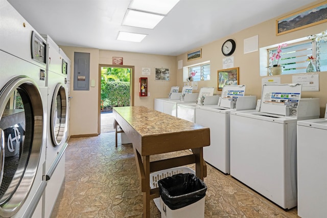 washroom with separate washer and dryer, electric panel, and stacked washer / dryer