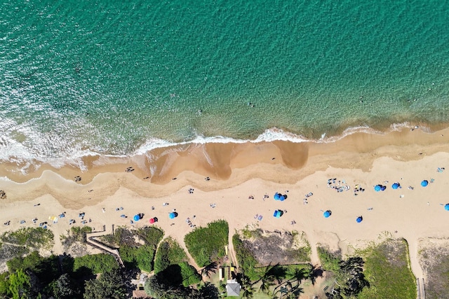 birds eye view of property featuring a water view and a beach view