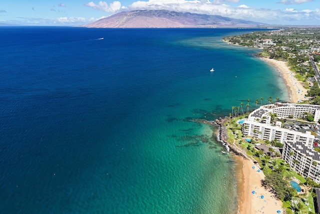 birds eye view of property featuring a view of the beach and a water and mountain view