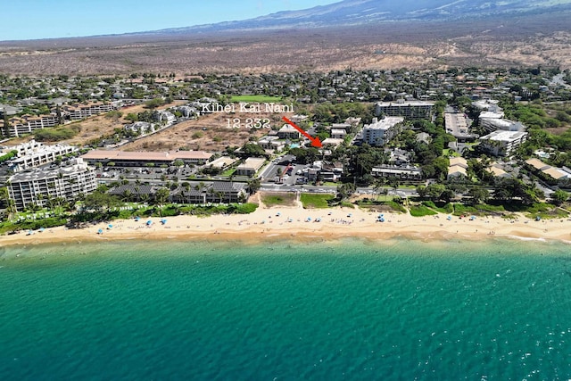 bird's eye view with a water view and a beach view