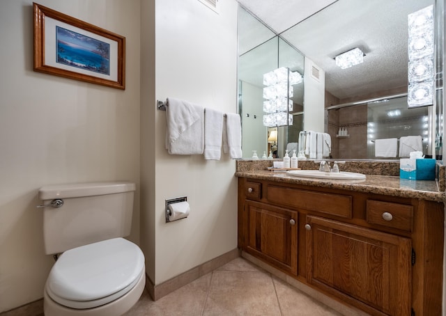 bathroom featuring tile patterned floors, walk in shower, vanity, a textured ceiling, and toilet