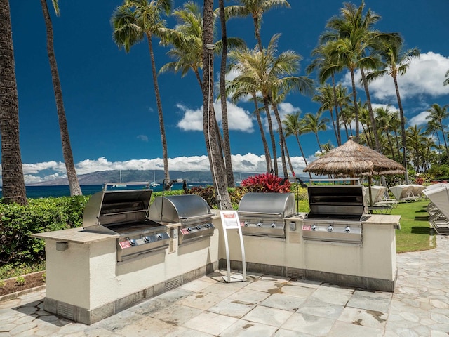 view of patio / terrace featuring a mountain view, a grill, and exterior kitchen