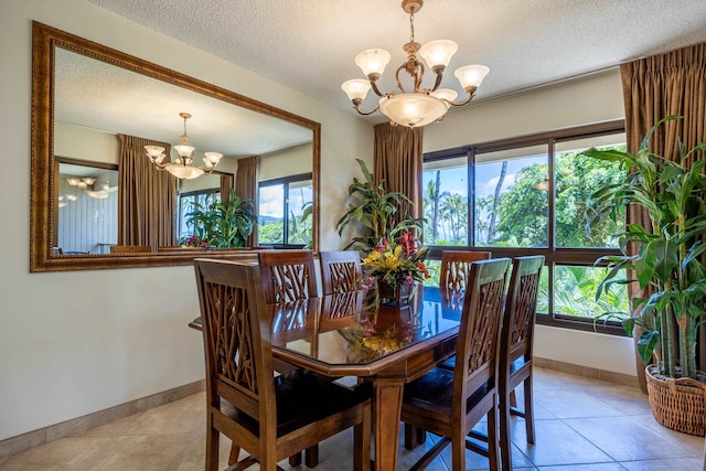 tiled dining space with a wealth of natural light, a chandelier, and a textured ceiling