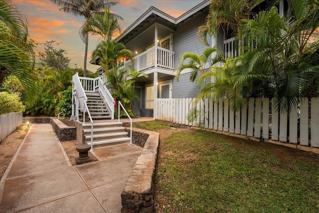 view of property's community featuring stairs and fence