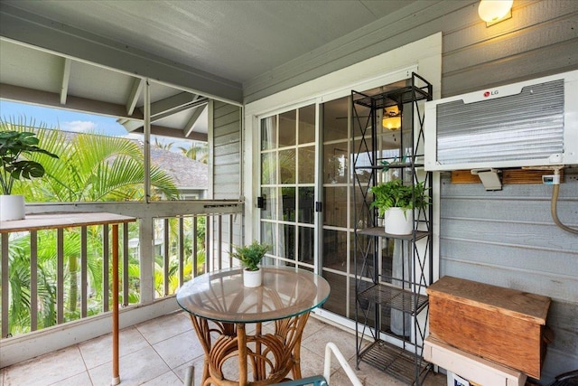balcony featuring covered porch and a wall mounted air conditioner