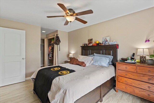 bedroom with a closet, ceiling fan, and light hardwood / wood-style flooring