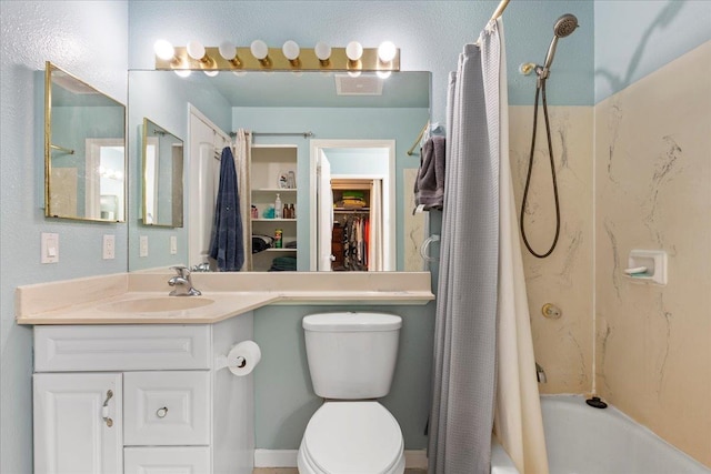 full bathroom featuring a walk in closet, vanity, toilet, and shower / bath combo with shower curtain
