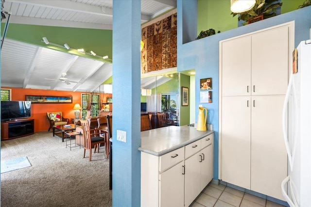 10 Wailea Ekolu Pl Unit 1008, Kihei, HI 96753 - kitchen featuring beam ceiling, freestanding refrigerator, white cabinets, ceiling fan, and light carpet
