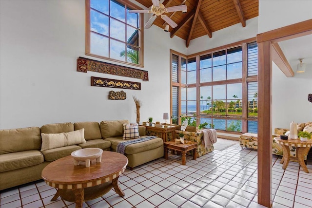 living room with wood ceiling, beamed ceiling, a water view, high vaulted ceiling, and light tile patterned floors