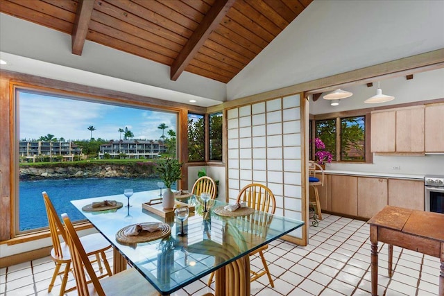 dining space with wooden ceiling, light tile patterned floors, lofted ceiling with beams, and a water view