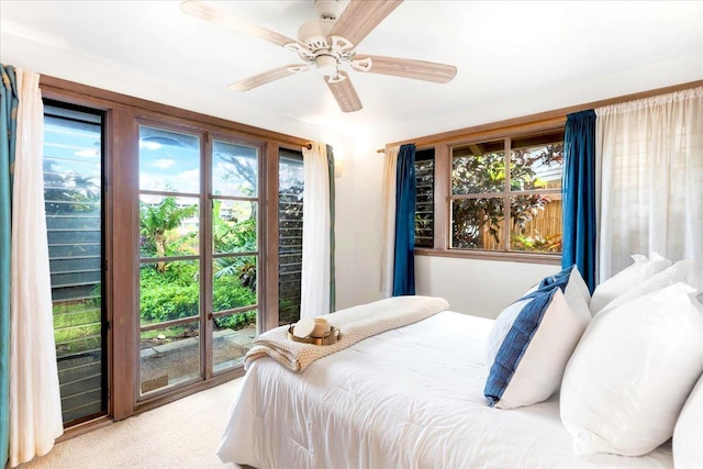 carpeted bedroom with access to exterior and ceiling fan