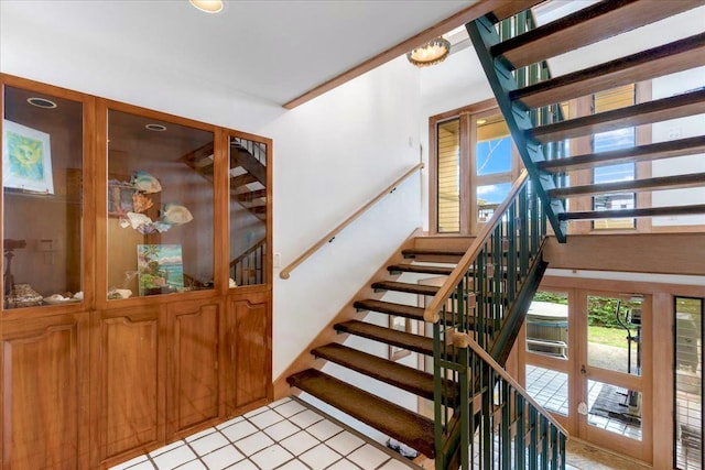 staircase with french doors and tile patterned flooring