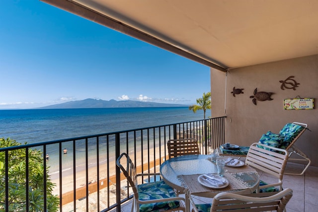 balcony featuring a beach view and a water and mountain view