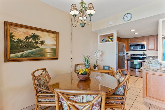 dining space with an inviting chandelier and light tile patterned flooring