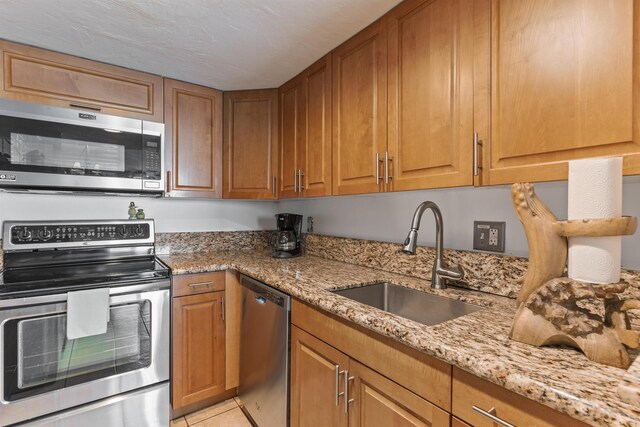 3723 Lower Honoapiilani Rd Unit 302, Lahaina, HI 96761 - kitchen featuring stainless steel appliances, a sink, light stone countertops, and light tile patterned floors