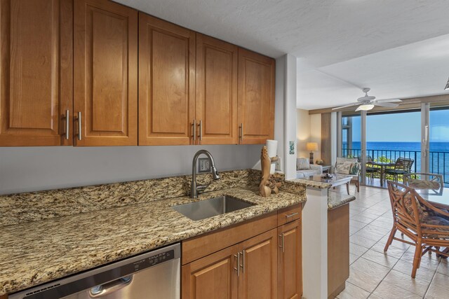 3723 Lower Honoapiilani Rd Unit 302, Lahaina, HI 96761 - kitchen with a sink, dishwasher, expansive windows, brown cabinetry, and light stone counters
