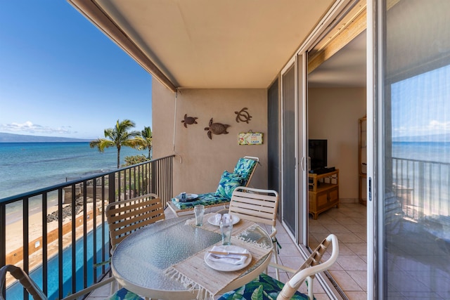 balcony with a view of the beach and a water view