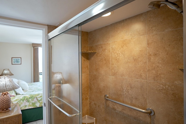 bathroom with a shower with door