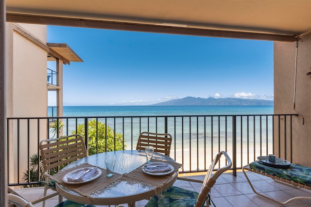 balcony featuring a water and mountain view and a beach view