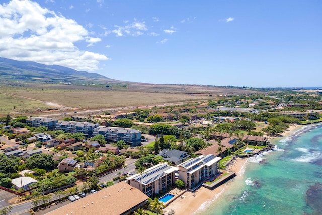 aerial view with a water and mountain view and a beach view