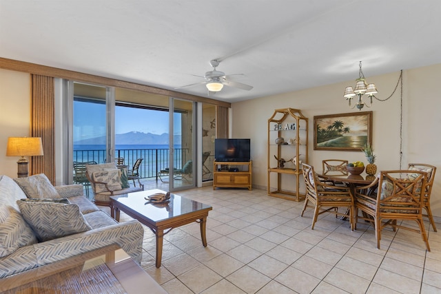 3723 Lower Honoapiilani Rd Unit 302, Lahaina, HI 96761 - living area with a chandelier, ceiling fan, light tile patterned flooring, and baseboards
