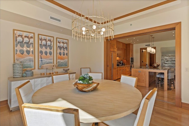 dining area featuring a notable chandelier and light hardwood / wood-style floors