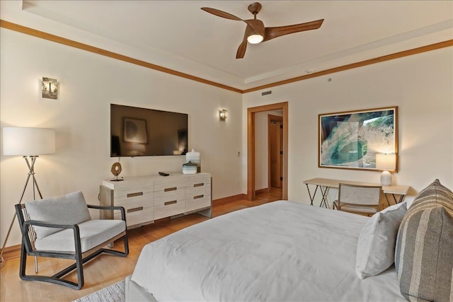 bedroom with ceiling fan, hardwood / wood-style flooring, and ornamental molding