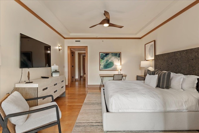 bedroom with ceiling fan, light hardwood / wood-style floors, and ornamental molding