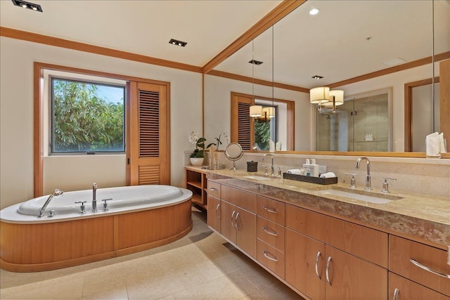 bathroom with a bathing tub, vanity, crown molding, and tile patterned flooring