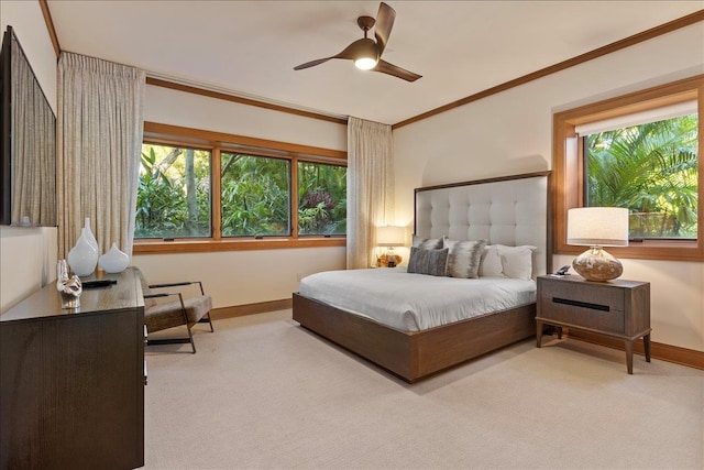 carpeted bedroom with ceiling fan and crown molding