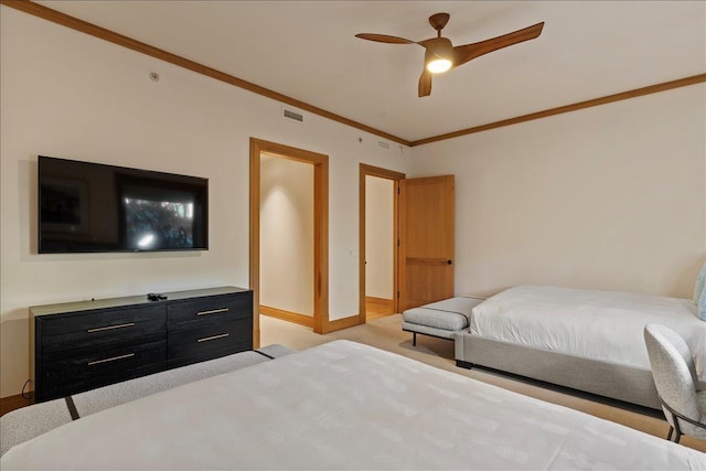 carpeted bedroom with ceiling fan and crown molding