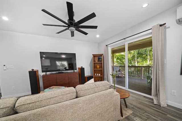 living room with a wall mounted air conditioner, dark wood-type flooring, and ceiling fan