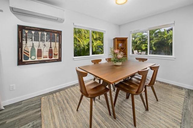 dining room featuring an AC wall unit and dark wood-type flooring