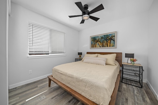 bedroom with dark hardwood / wood-style floors and ceiling fan