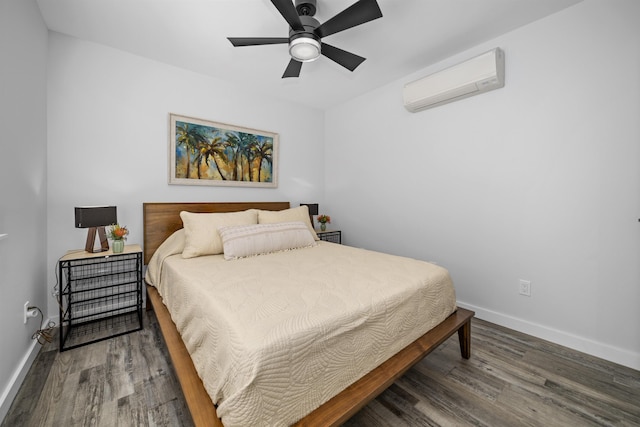 bedroom featuring dark wood-type flooring, a wall mounted AC, and ceiling fan