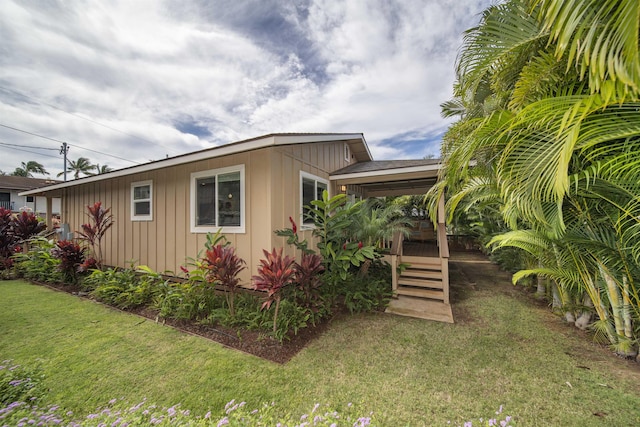 view of side of property with a yard