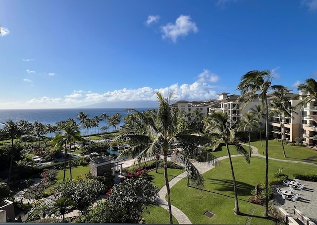 surrounding community with a lawn and a water view