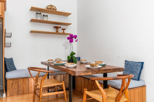 dining area featuring breakfast area and light wood-type flooring